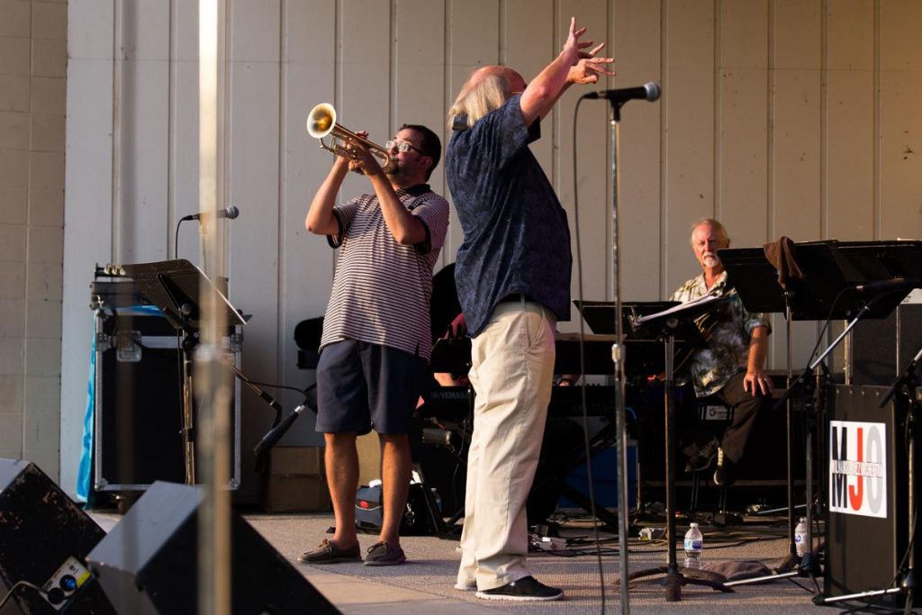 Jaime Breiwick, left, plays the trumpet as Curt Hanrahan conducts the Milwaukee Jazz Orchestra at th