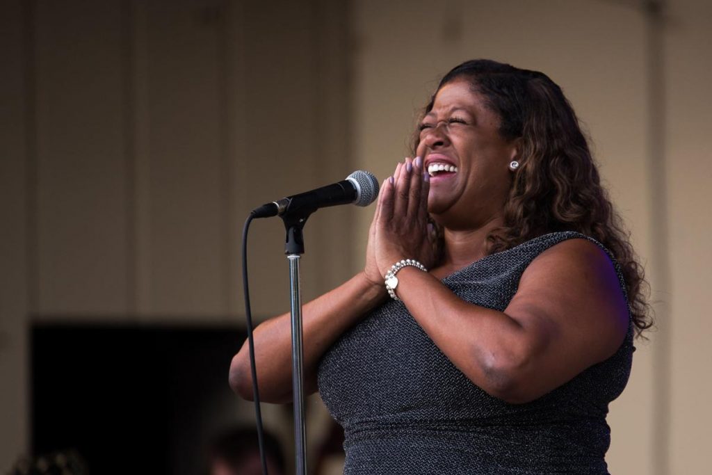 Michelle Coltrane reacts after singing a song with the Milwaukee Jazz Orchestra